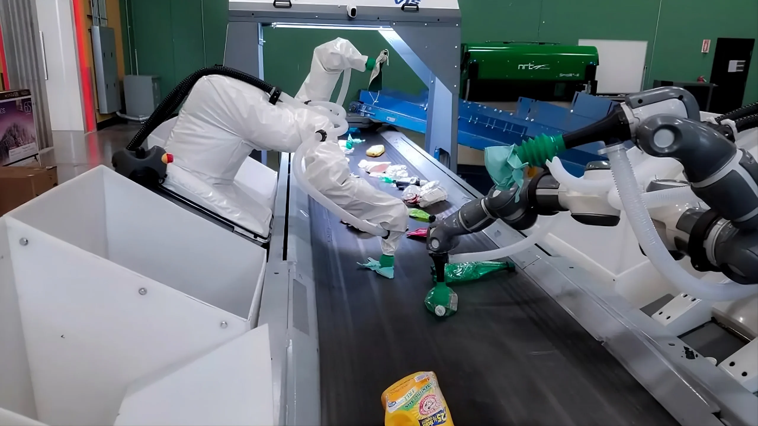 Robots sorting waste at a waste management facility